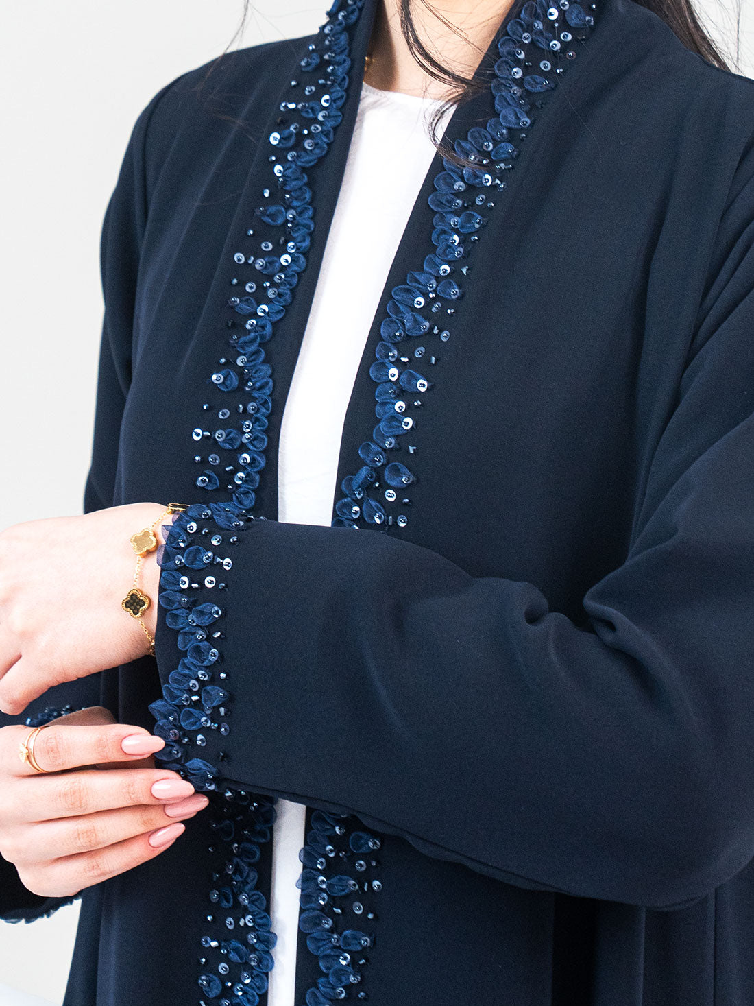 Close-up of Midnight Petal Abaya beaded sequin front panel and cuff detail in navy - Layaal