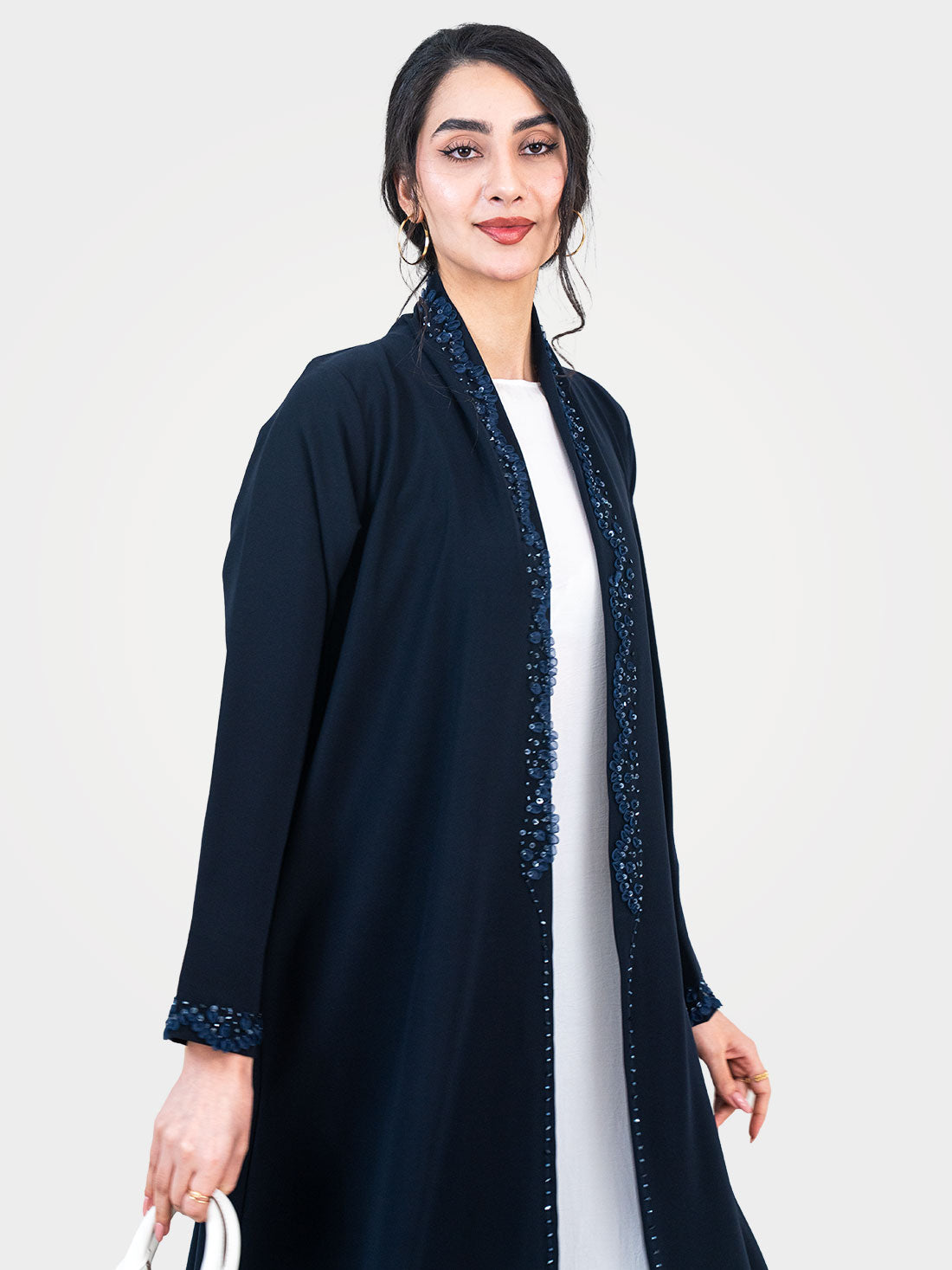 Midnight Petal Abaya in navy with beaded sequin front trim worn open over white dress - Layaal