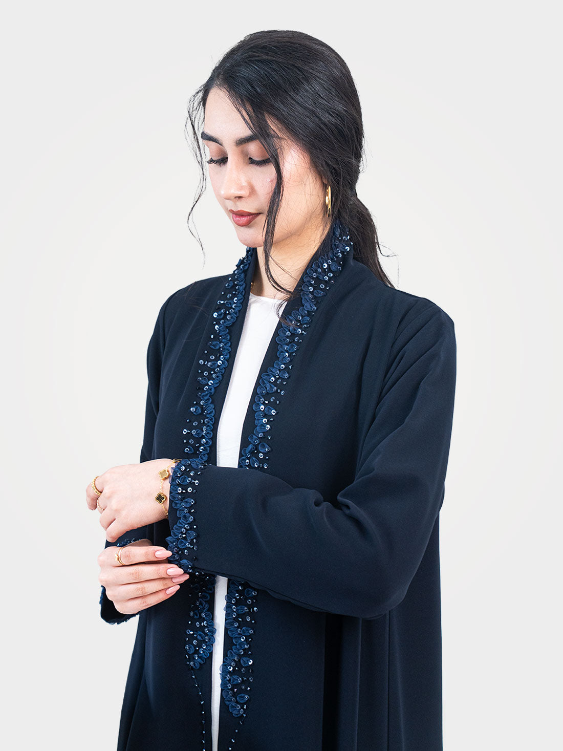 Midnight Petal Abaya in navy with beaded sequin lapel detail styled with arms crossed - Layaal