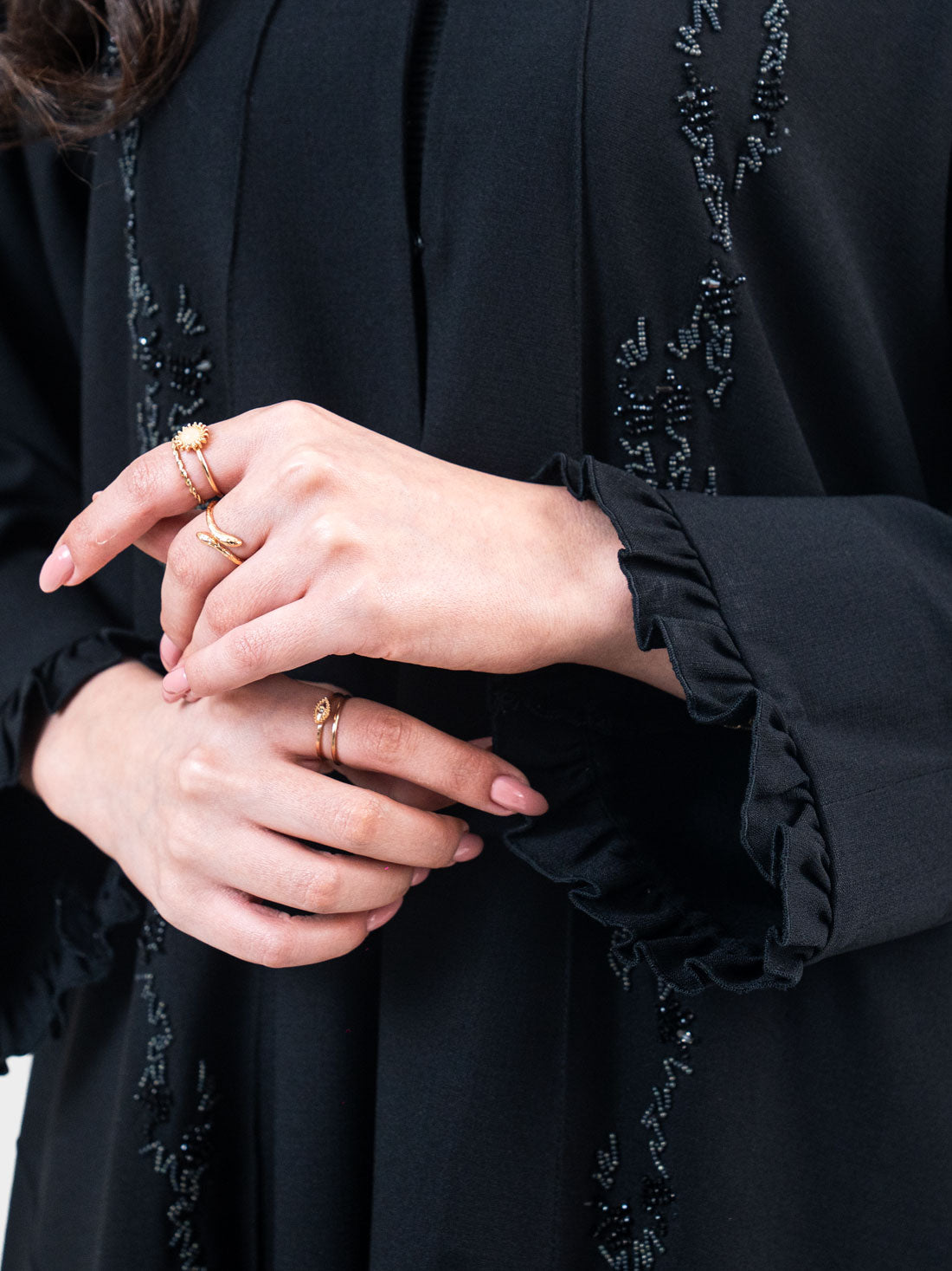 Noir Ruffle Abaya close-up of gathered ruffle cuff trim and tonal black micro-bead sequin branch embellishment