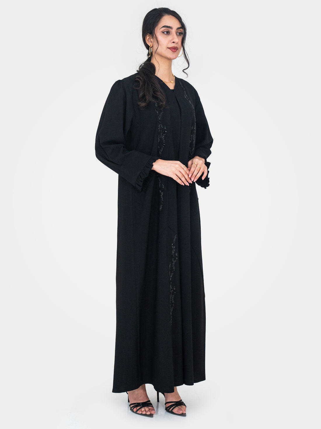 Noir Ruffle Abaya full length side view showing tonal bead sequin embellishment panels on black twill crepe UAE