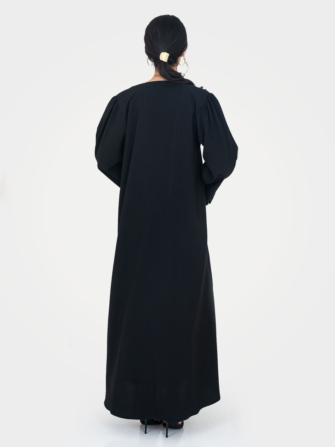 Noir Ruffle Abaya back view showing dramatic puff shoulders and full length black twill crepe silhouette UAE